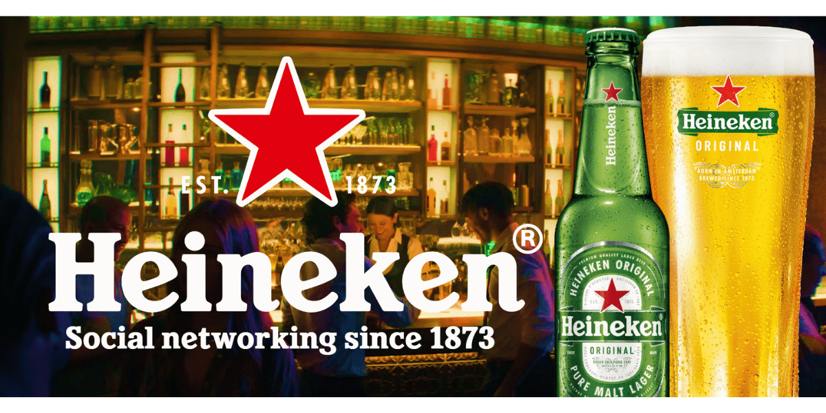 Heineken Original beer bottle and pint glass in front of a busy bar, with the Heineken logo and the slogan Social networking since 1873. Heineken Original beer bottle and pint glass in front of a busy bar, with the Heineken logo and the slogan Social networking since 1873.